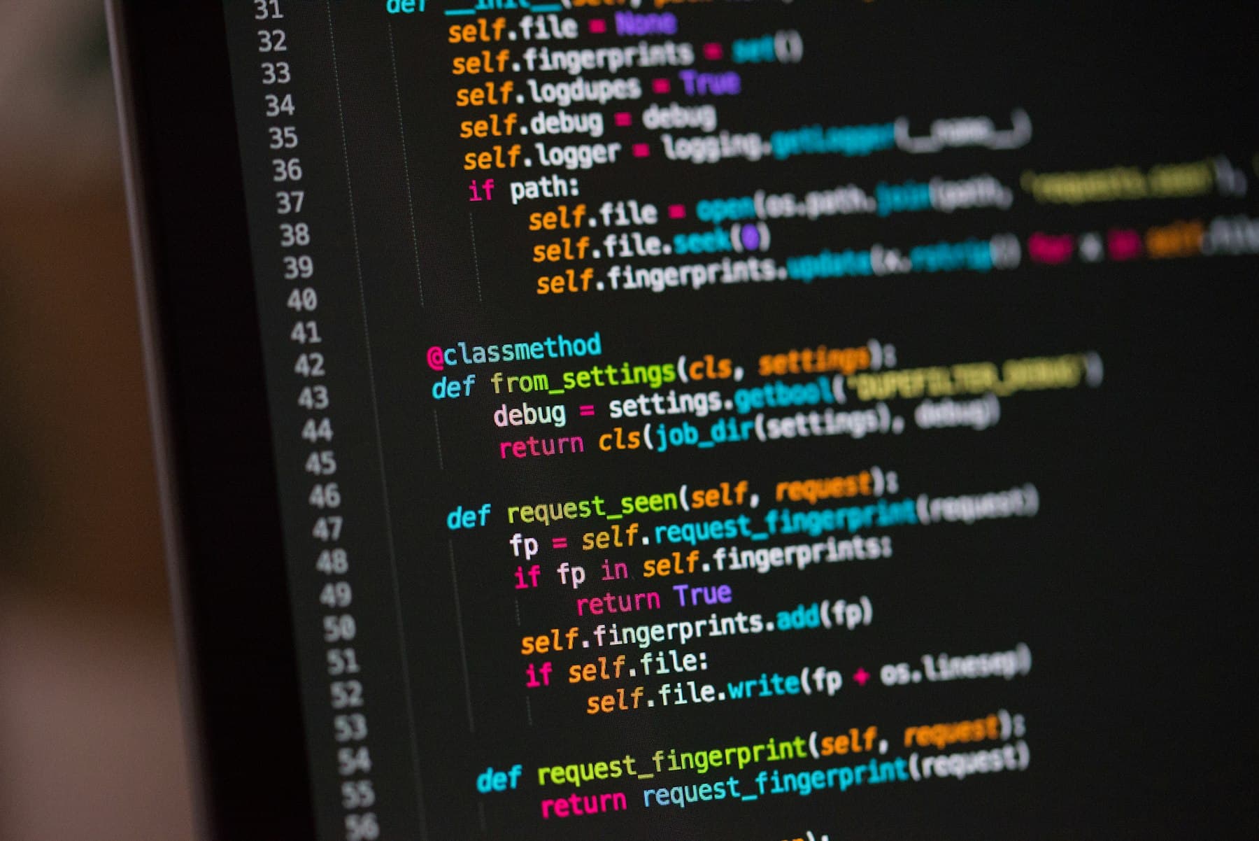 Close-up of Python source code in a dark-themed editor, slightly angled